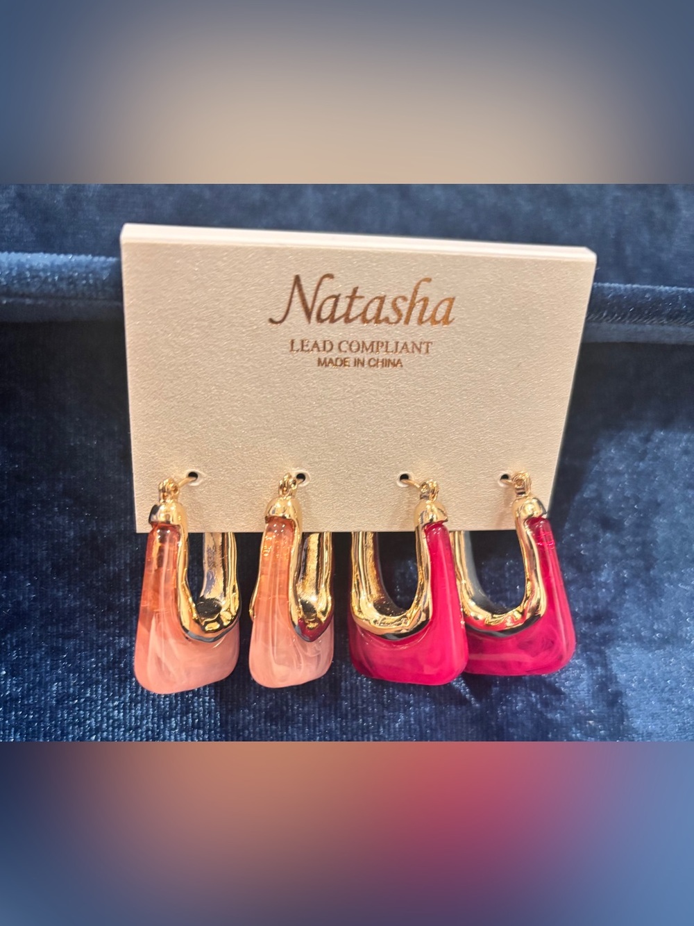 NWT “Natasha” 2 pair resin oval hoop earrings with a metallic gold-tone cap.